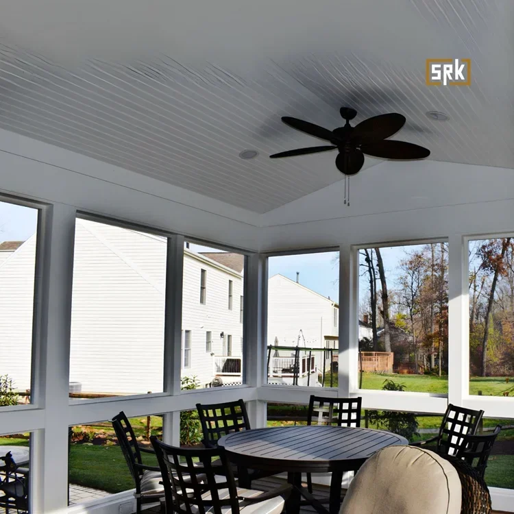 Screened porch with white frame, black ceiling fan, composite deck, and black outdoor furniture