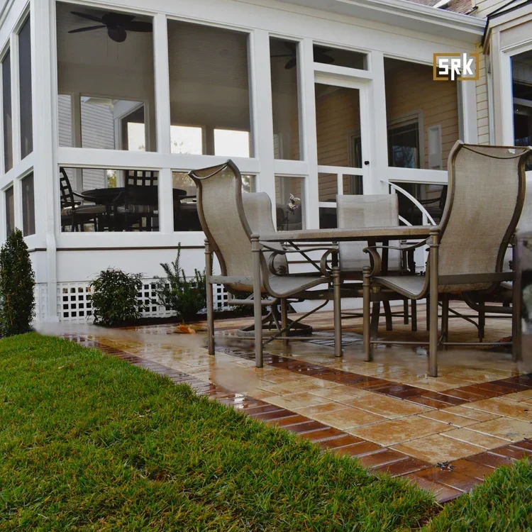 White screened porch with clay tile patio and outdoor furniture overlooking lawn
